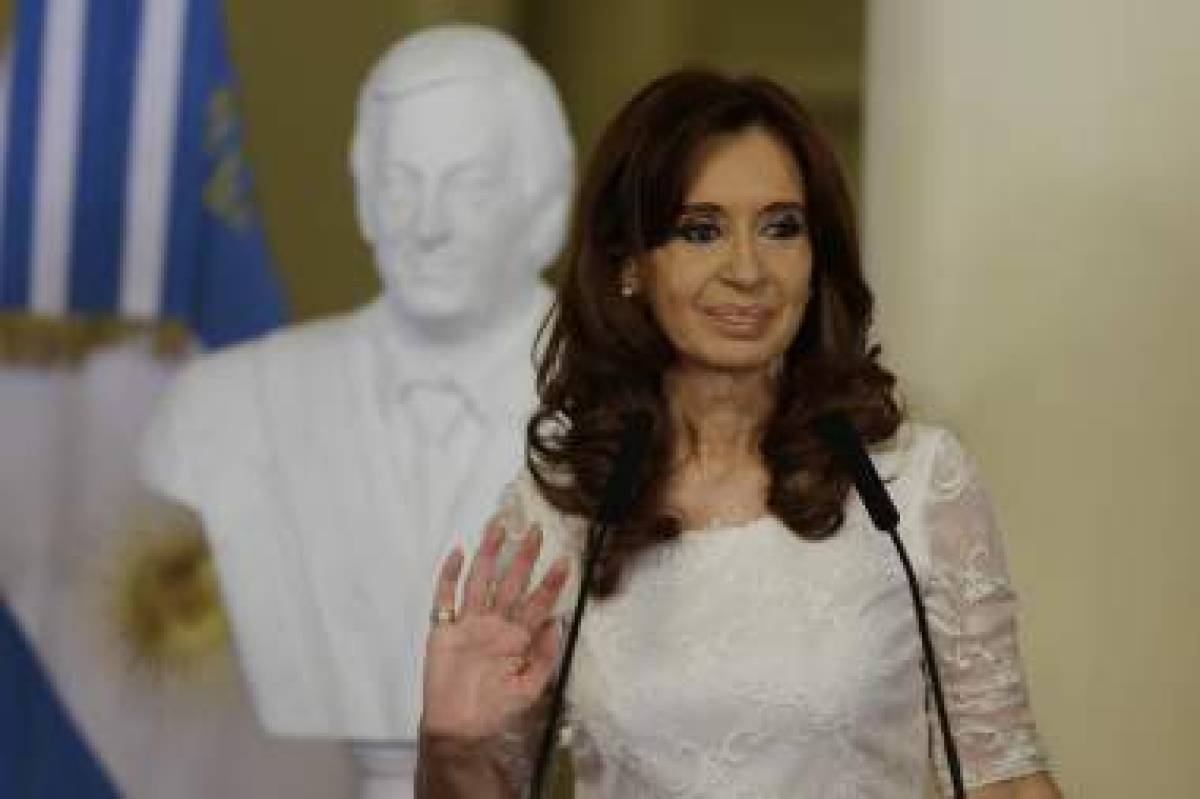 President Cristina Fernandez speaks after unveiling a bust of her late husband, and former president, Nestor Kiirchner, back, at the presidential palace in Buenos Aires, Argentina, Wednesday, Dec. 9, 2015. After eight years in office Fernandez will be replaced by Mauricio Macri on Dec. 10. (AP Photo/Ricardo Mazalan)