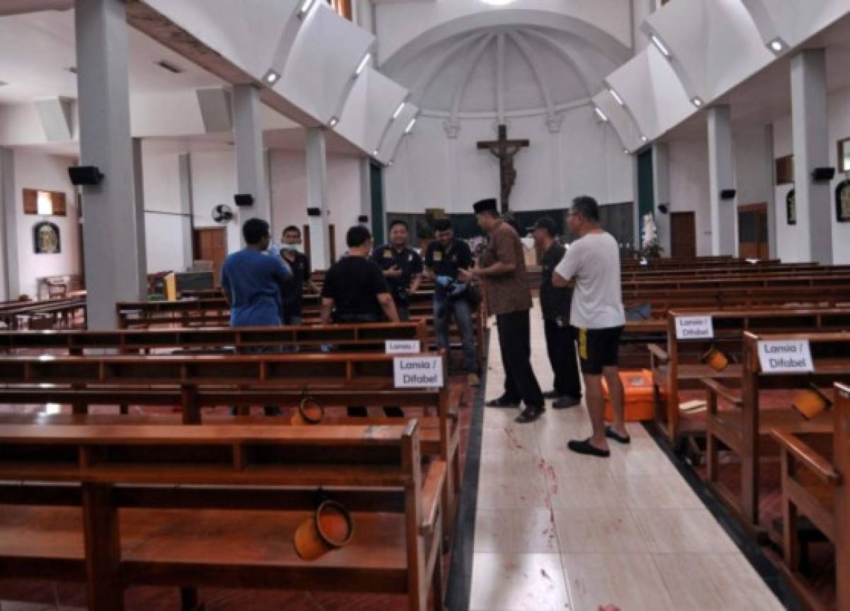 Agentes de policía investigan dentro de la iglesia St. Lidwina después de un ataque en Sleman, provincia de Yogyakarta, Indonesia, el domingo 11 de febrero de 2018. La policía disparó contra un hombre armado con espadas que atacó la iglesia durante una misa, hiriendo a varias personas, incluyendo un alemán sacerdote. El motivo del ataque del domingo por la mañana no fue inmediatamente claro. (AP Photo / Slamet Riyadi).