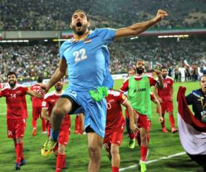 Syria's national soccer team celebrates at the conclusion of their match with Iran which drew 2-2 during their Round 3 - Group A World Cup qualifier at the Azadi Stadium in Tehran, Iran, Tuesday, Sept. 5, 2017. (AP Photo/Vahid Salemi)