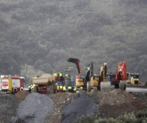 Fotografía de una perforadora y máquinas de excavación trabajando sobre una montaña junto al pozo en donde está atrapado un niño de dos años en Totalán, Málaga, España. Foto AP