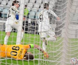 El delantero español de la Juventus, Álvaro Morata celebra con Federico Chiesa después de anotar el portero húngaro del Ferencvaros, Denes Disbusz durante el partido de fútbol del Grupo G de la Liga de Campeones de la UEFA. Foto: AFP.