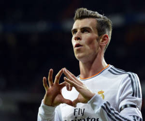 Real Madrid's Welsh forward Gareth Bale celebrates after scoring a goal during the Spanish league football match Real Madrid CF vs Real Valladolid CF at the Santiago Bernabeu stadium in Madrid on November 30, 2013. AFP PHOTO/ GERARD JULIEN