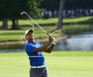 Tiger Woods observa su tiro desde el fairway del séptimo hoyo en la tercera ronda del Tour Championship. (Foto: AP)