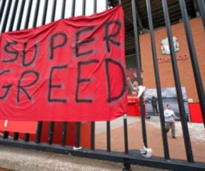 Aparece una manta con un mensaje de protesta contra la Superliga, a la que califica de 'Supercodicia', en las rejas del estadio Anfield de Liverpool. Foto: AP