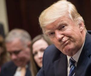 TOPSHOT - US President Donald Trump attends a meeting about healthcare in the Roosevelt Room at the White House in Washington, DC, on March 13, 2017. / AFP PHOTO / NICHOLAS KAMM