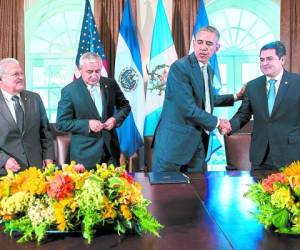 President of El Salvador Salvador Sanchez Ceren (L) and President of Guatemala Otto Perez Molina (2nd L) wait as US President Barack Obama (2nd R) and President of Honduras Juan Orlando Hernandez (R) shake hands after a meeting in the Cabinet Room of the White House on July 25, 2014 in Washington. The four presidents met to speak about the amount of immigrants, specifically children, leaving the Central American region for other countries including the United States. AFP PHOTO/Brendan SMIALOWSKI