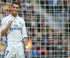 (FILES) This file photo taken on December 3, 2016 shows Real Madrid's Portuguese forward Cristiano Ronaldo gesturing during the Spanish league football match FC Barcelona vs Real Madrid CF at the Camp Nou stadium in Barcelona.Atletico Nacional will play through their grief over the Chapecoense plane tragedy when they tackle the Club World Cup in Japan -- just days after their Copa Sudamericana final opponents were wiped out. FIFA's global club showpiece, which will also feature Ronaldo's Real Madrid, begins this week under the shadow of the air crash that sent football into mourning. / AFP PHOTO / Lluis GENE