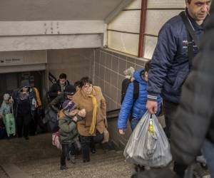 Evacuados ucranianos se apresuran a subir a un tren camino de Varsovia en la estación de tren de Przemysl, cerca de la frontera polaco-ucraniana.