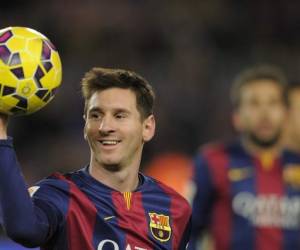 FILE - This is a Sunday, Dec. 7, 2014 file photo of FC Barcelona's Lionel Messi holding the ball after scoring a hat-trick in the Spanish La Liga soccer match between FC Barcelona and Espanyol at the Camp Nou stadium in Barcelona, Spain. The 2015 Ballon dOr award is on Monday Jan. 11, 2016 in Zurich and Messi is strongly favored to be named FIFA best player for a fifth time. Ronaldo has won it three times including the past two years. Messis Barcelona teammate Neymar is the other candidate. (AP Photo/Manu Fernandez, File)