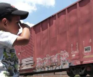 Un pequeño hondureño mira al otro lado de la cerca durante un descanso en su ruta migratoria a Estados Unidos....