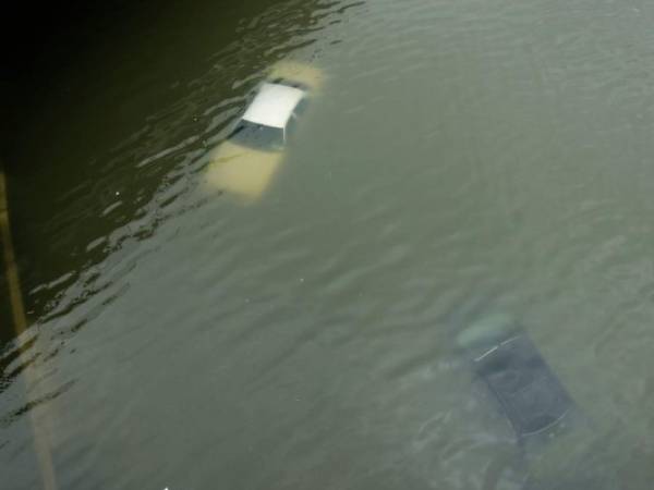 Varios carros quedaron bajo el agua, hasta el momento se desconoce si habrían más personas atrapadas en otros vehículos. Foto: AP