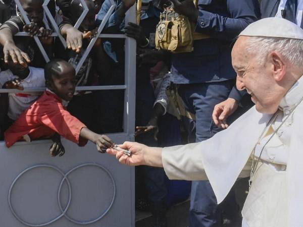 En la foto, que fue compartida por Noticias del Vaticano, puede apreciarse a un niño que, a través de una verja que lo separaba de la calle por la que pasa el Pontífice, se desplazaba en silla de ruedas, le ha entregado el billete.