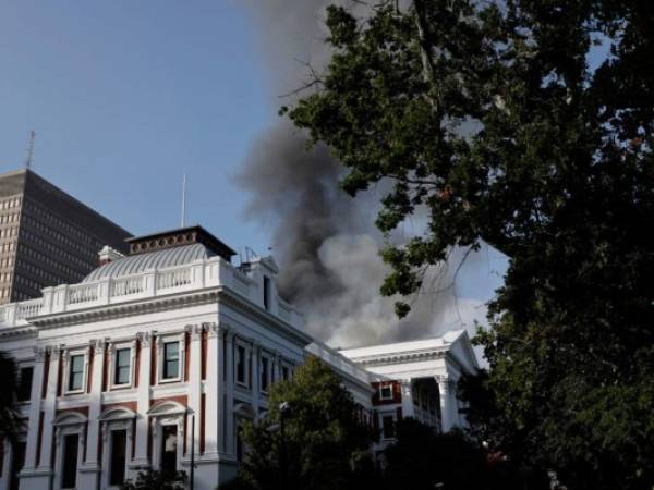 El humo sale del techo de un edificio en el recinto del Parlamento sudafricano en Ciudad del Cabo el 2 de enero de 2022, durante un incendio. Foto: AFP