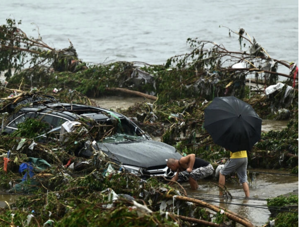 Coche arrastrado por las inundaciones provocadas por las lluvias torrenciales en Pekín, el 1 de agosto de 2023 en el distrito de Fangshan.