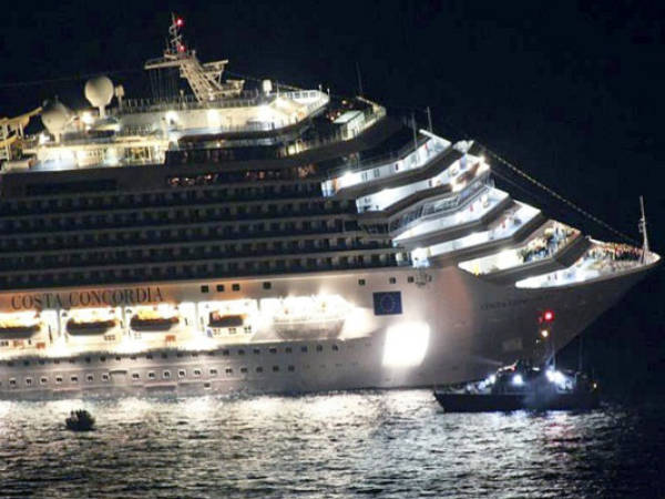 Rescuers surround the luxury cruise ship Costa Concordia after it ran aground off the coast of Isola del Giglio island, Italy, gashing open the hull and forcing some 4,200 people aboard to evacuate aboard lifeboats to the nearby Isola del Giglio island, early Saturday, Jan. 14, 2012. About 1,000 Italian passengers were onboard, as well as more than 500 Germans, about 160 French and about 1,000 crew members. (AP Photo/Giglionews.it, Giorgio Fanciulli)