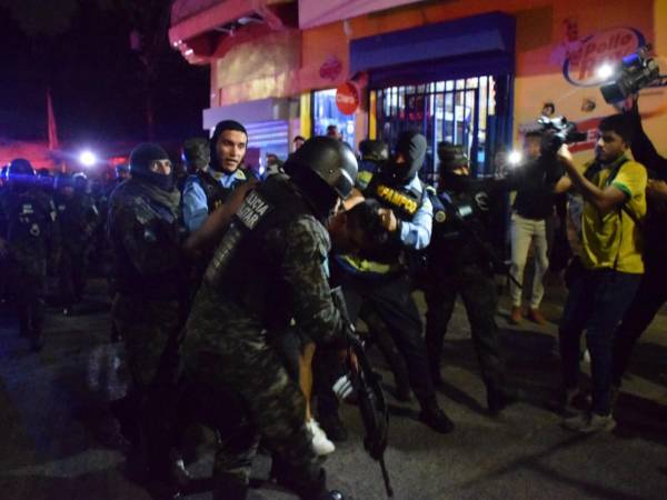 Momento en que elementos de la Policía Militar llevaban detenidos a varios sospechosos en el mismo sitio donde un enfrentamiento dejó dos personas muertas.