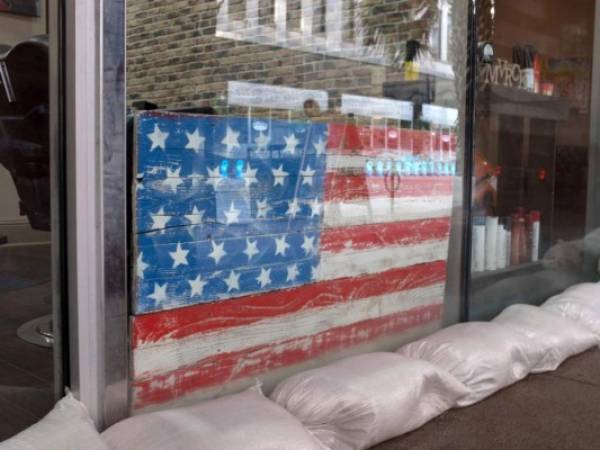 Sandbags line store front of a barber shop in preparation for tropical storm Barry in New Orleans, Louisiana, on July 11, 2019. - Tropical storm Barry barreled toward rain-soaked New Orleans on July 11 as the city hunkered down for an ordeal that evoked fearful memories of 2005's deadly Hurricane Katrina. Barry is predicted to become a Category 1 hurricane before making landfall Saturday with maximum winds reaching 75 mph. (Photo by Seth HERALD / AFP)