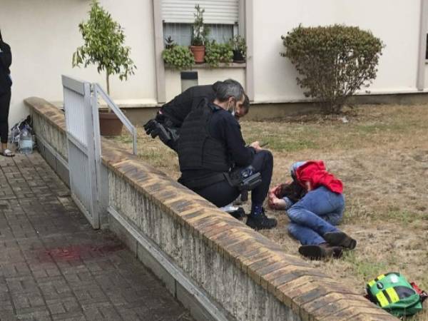 Un hombre que se encuentra en el suelo es auxiliado después de que fuera herido durante un ataque con arma blanca en París, el viernes 25 de septiembre de 2020. (David Cohen vía AP).