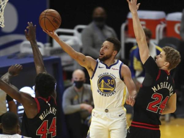 Golden State Warriors coach Steve Kerr, left, celebrates with guard Stephen Curry after the Warriors defeated the Milwaukee Bucks in an NBA basketball game in San Francisco, Tuesday, April 6, 2021. (AP Photo/Jeff Chiu)