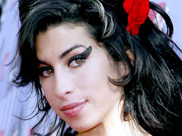 FILE in this June 3, 2007, file photo British singer Amy Winehouse arrives at the MTV Movie Awards in Los Angeles. The family of Amy Winehouse has put the late singer's London home up for sale for 2.7 million pounds ($4.2 million).The three-bedroom property in the Camden neighborhood of northwest London had become a shrine of sorts for mourning fans who left flowers and tributes following Winehouse's death last July from alcohol poisoning. A spokesman for the Winehouse family, said Thursday May 31, 2012 that the singer had loved the house and her family put it on the market because they felt it would be inappropriate for any of them to live there. (AP Photo/Kevork Djansezian, File)