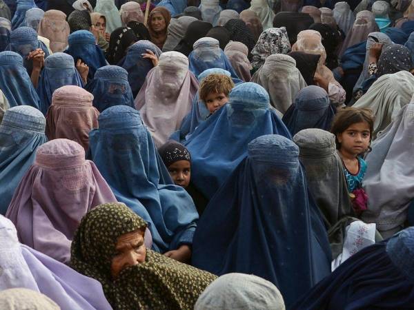 Las mujeres con sus hijos esperan recibir una donación de alimentos de la fundación Afterlife durante el Ramadán, el mes sagrado del ayuno del Islam, en Kandahar el 27 de abril de 2022.