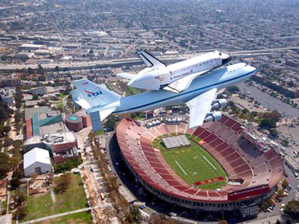 The space shuttle Endeavour atop the 747 shuttle carrier aircraft is seen flying over the LA Coliseum in Los Angeles during the final portion of its tour of California, Friday, Sept. 21, 2012. The tour, including numerous flyovers of cities and landmarks in Northern and Southern California, would conclude with a landing at Los Angeles International Airport where Endeavour would be turned over to the California Science Center for permanent exhibit. (AP Photo/NASA, Jim Ross)