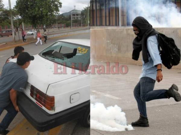 Un grupo de manifestantes encapuchados protagonizó este lunes en hora de la tarde un fuerte disturbio en Ciudad Universitaria. Producto del lanzamiento de piedras y objetos pesados los parabrisas al menos dos taxis se quebraron. Foto Johny Magallanes| EL HERALDO