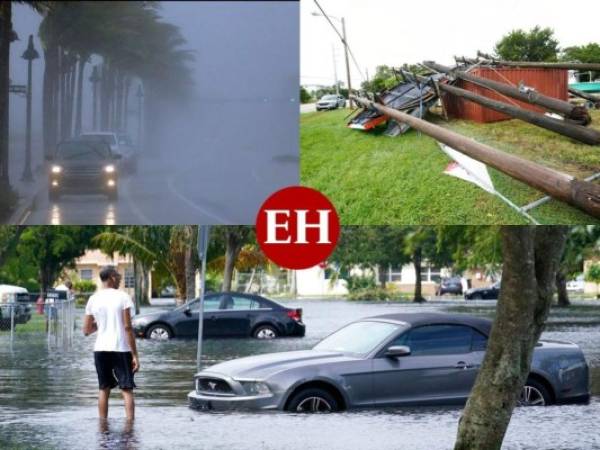 A woman walks through the flooded street during heavy rain and wind as tropical storm Eta approaches the south of Florida, in Miami, Florida on November 9, 2020. - Tropical storm Eta brought strong winds and torrential rain to Cuba on Sunday after having cut a destructive and deadly path through parts of Central America and southern Mexico. (Photo by CHANDAN KHANNA / AFP)