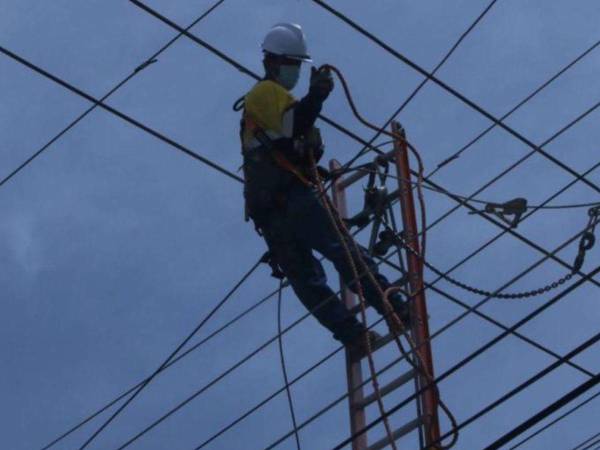 Imagen de un empleado de la ENEE realizando labores de mantenimiento en un sector de Tegucigalpa, capital del país.