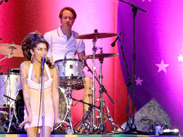 FILE- In this Jan. 8, 2011 file photo, British artist Amy Winehouse, left, performs during her show in Florianopolis, Brazil. Winehouse died one year ago on July 23, 2011 at her London home from accidental alcohol poisoning at age 27. (AP Photo/Nabor Goulart, File)