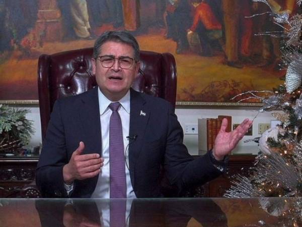 Juan Orlando Hernández deberá entregar el poder este 27 de enero a la presidenta electa Xiomara Castro. FOTO: AFP