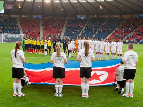 CORRECTS GROUP MATCH TO G INSTEAD OF B- The North Korean women's soccer team sing their nation anthem before the group G match between Colombia and North Korea, prior to the start of the London 2012 Summer Olympics, Wednesday, July 25, 2012, at Hampden Park Stadium in Glasgow. (AP Photo/Chris Clark)