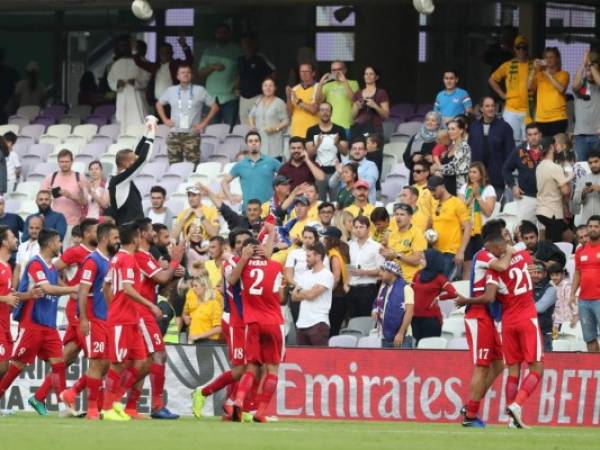 Jordan's goalkeeper Amer Shafi (up) and his teammates celebrate after winning the 2019 AFC Asian Cup football game between Australia and Jordan at the Hazza Bin Zayed stadium in Al-Ain on January 6, 2019. (Photo by KARIM SAHIB / AFP)