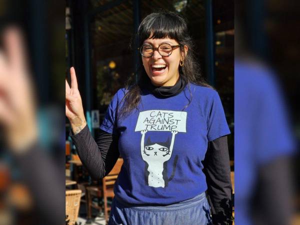 Una mujer luce una camiseta que dice ‘Gatos contra Trump’, tras depositar su voto en un centro de votación en el vecindario de El Barrio, el tradicional vecindario puertorriqueño de Nueva York.