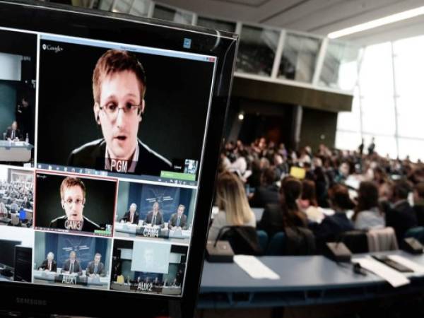 American National Security Agency (NSA) whistleblower Edward Snowden speaks to European officials via videoconference during a parliamentary hearing on mass surveillance at the European Council in Strasbourg, eastern France, on April 8, 2014. Snowden pleaded for new international norms on surveillance, to avoid the kinds of abuses committed by the NSA, especially as high-tech surveillance practices become widespread worldwide. AFP PHOTO / FREDERICK FLORIN