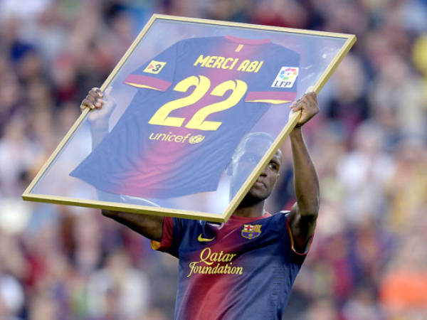 Barcelona's French defender Eric Abidal holds a shirt reading 'Merci Abi 22' during a tribute in his honor after the Spanish league football match FC Barcelona vs Malaga CF at the Camp Nou stadium in Barcelona on June 1, 2013. Abidal announced on May 31, 2013 he was leaving the club at the end of the season AFP PHOTO/ LLUIS GENE