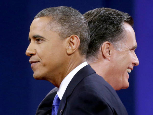 FILE - In this Oct. 22, 2012 file photo, Republican presidential candidate, former Massachusetts Gov. Mitt Romney and President Barack Obama walks past each other on stage at the end of the last debate at Lynn University in Boca Raton, Fla. Obama and Romney courted the Hispanic community during the campaign, but only spent $ 22.8 million on advertising on Spanish language television, from a total cost of $ 355 million on television advertizing in 10 states, according to the Hispanic Chamber of Commerce of the United States on Friday, Nov. 16, 2012. (AP Photo/Pablo Martinez Monsivais, File)