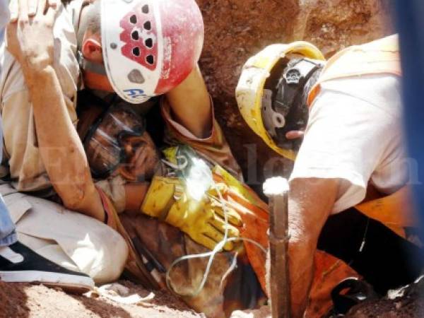 “Ayúdenme, por favor no me dejen morir”, fueron las desgarradoras palabras de Julio César Gálvez Sierra, de 29 años.Este obrero quedó soterrado en el derrumbe de una construcción en el bulevar Kuwait el 2 de junio del año que hoy termina. Elementos del Cuerpo de Bomberos realizaron arduas labores de salvamento. Los rescatistas Braulio López y Edwin Mondragón asistieron al trabajador con suero, oxígeno y careta protectora para estabilizarlo mientras trataban de liberar su cuerpo de los escombros.Sin embargo, pese a todos los esfuerzos, Julio César falleció una hora después debido a los golpes internos que sufrió. Foto: Estalin Irias/El Heraldo.