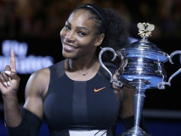 FILE - In this Jan. 28, 2017, file photo, Serena Williams holds up a finger and her trophy after defeating her sister, Venus, in the women's singles final at the Australian Open tennis championships in Melbourne, Australia. Williams posed nude for the cover of Vanity Fair in an image released by the magazine on June 27, 2017. (AP Photo/Aaron Favila, File)