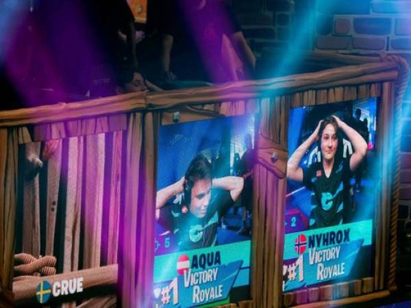 Emil 'Nyhrox' Bergquist Pedersen (R) and Thomas 'Aqua' Arnould react as they win a match during the Duos competition at the 2019 Fortnite World Cup July 27, 2019 inside of Arthur Ashe Stadium, in New York City. (Photo by Johannes EISELE / AFP)