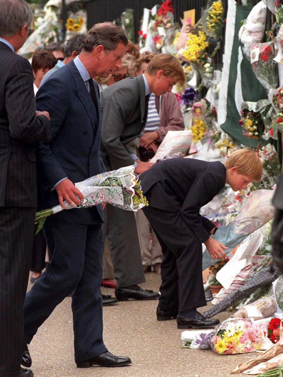 Luego de pasar unos días en Balmoral tras la muerte de su madre Diana, el príncipe Carlos junto a William y Harry recorren las afueras del Palacio de Buckingham para contemplar el altar improvisado que hicieron para la difunta princesa.